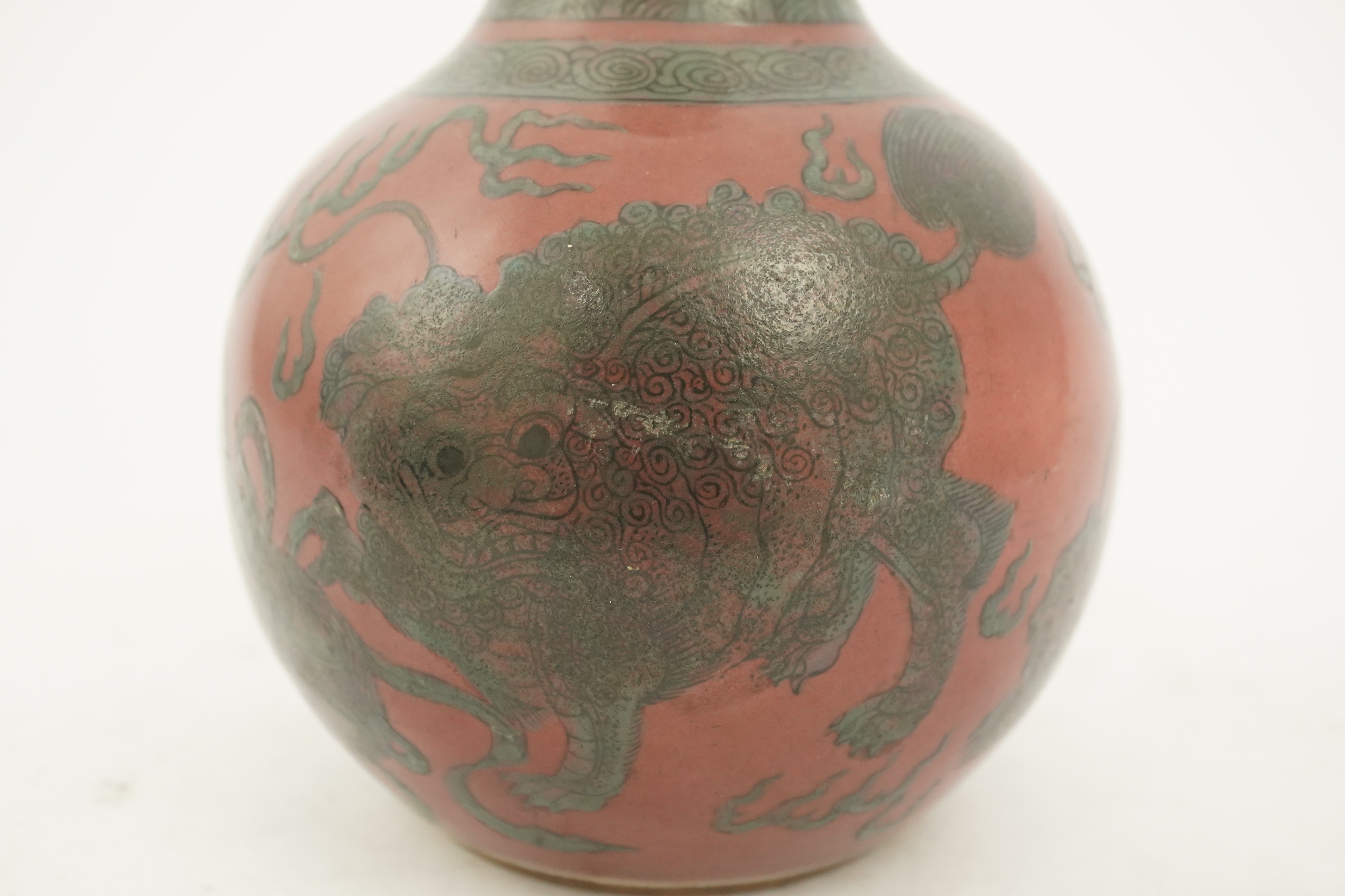 A Chinese green enamelled sang de boeuf ground 'lion' bottle vase, probably 18th century